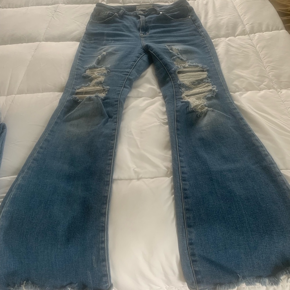 Women’s distressed, High rise denim jean.